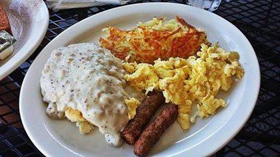 Biscuits and gravy with eggs, hash browns and sausage links